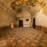 Raggiungiamo quindi il piano nobile e accediamo da una porta in legno a un ampio salone con un�alta volta anch�essa rovinata dall�incuria