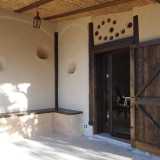 La veranda-ingresso della Casa di paglia: gli incavi nel muro ospitano lumi e candele