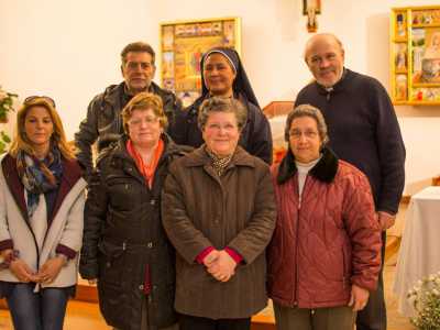 Il parroco e ex-profugo greco Giorgio Lionetti con alcuni fedeli del Villaggio all'interno della chiesa