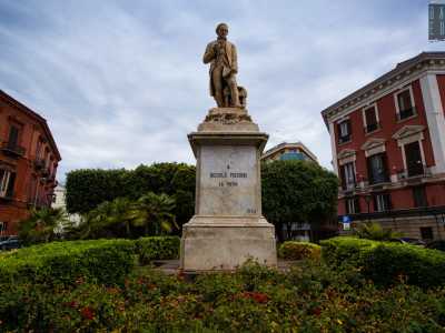 La splendida statua infatti, inserita tra i giardini di piazza Massari e il rosso edificio di Palazzo Diana...