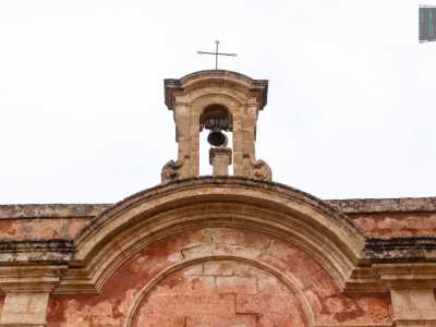 Pi� in alto un finestrone ornato da un doppio frontone ad arco introduce a un piccolo campanile