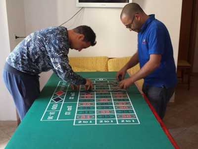 Due croupier posizionano le chips in un tavolo da roulette 