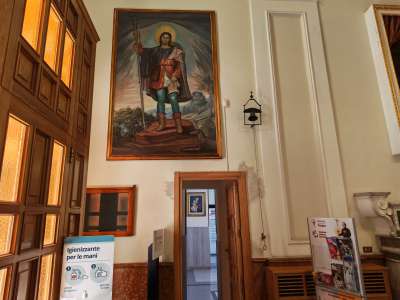 Proseguendo verso la navata sinistra, sopra l�ingresso per la sagrestia e gli uffici parrocchiali, spicca la tela di San Rocco