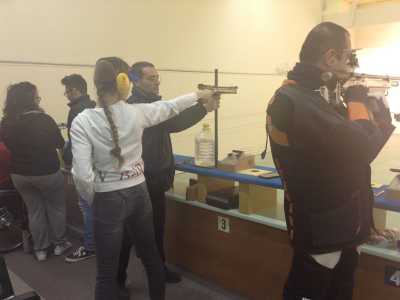 Marianna Rotolo mentre si prepara a mirare con la pistola ad aria compressa, aiutata dal suo allenatore