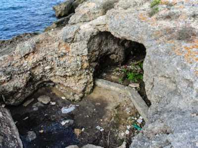 Rifiuti davanti all'ingresso della grotta di Cala Scizzo