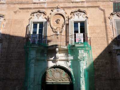 L'ingresso � costituito da un possente portale caratterizzato da due colonne ioniche laterali che sostengono il peso del balcone centrale. Quest'ultimo accoglie tra due finestre lo stemma dell'antica famiglia