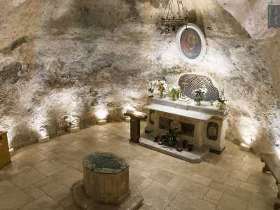 La cappella si trova per l�appunto nel pozzo, in una grotta, nella quale � possibile accedere attraverso una rampa. Una decina di scalini portano nella cavit� dove subito notiamo un altarino sovrastato da un quadro grazioso: raffigura Maria con in braccio il Messia benedicente