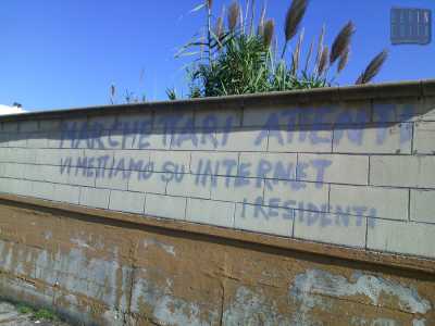 Su un muretto della strada compare una minaccia firmata dai residenti (foto di Mina Barcone)