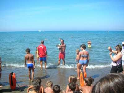 Due bagnini in spiaggia informano la gente sulla sicurezza balneare 