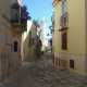 Un vico del centro srorico e, in lontananza, il campanile